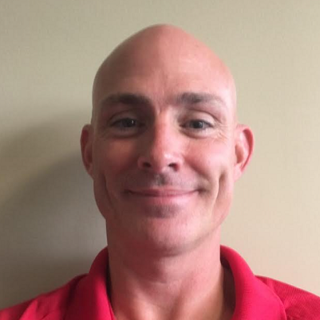 Headshot of Matthew Turner smiling in a red shirt