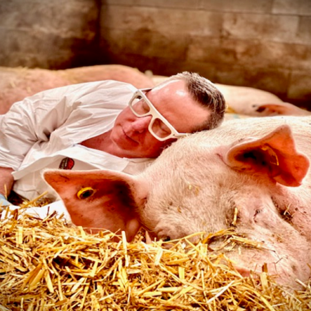 PJ Corns snuggling with a sleeping pig